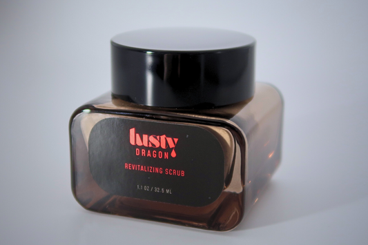 Lusty Dragon Revitalizing Scrub — 1.1 oz vegan exfoliating treatment for tattoo care, shown in dark amber glass jar with black lid